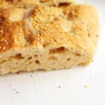A close up photo of a Mediterranean tahini flatbread.