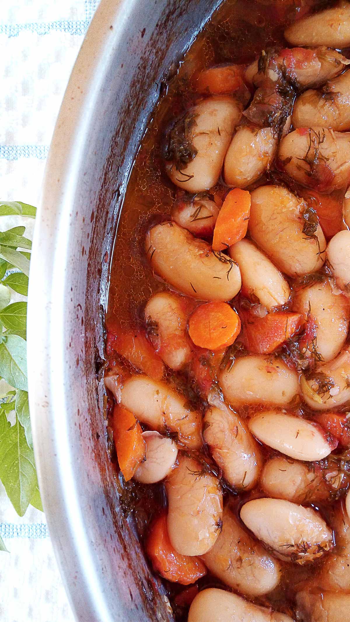 A baking tray with cooked Greek giant beans.