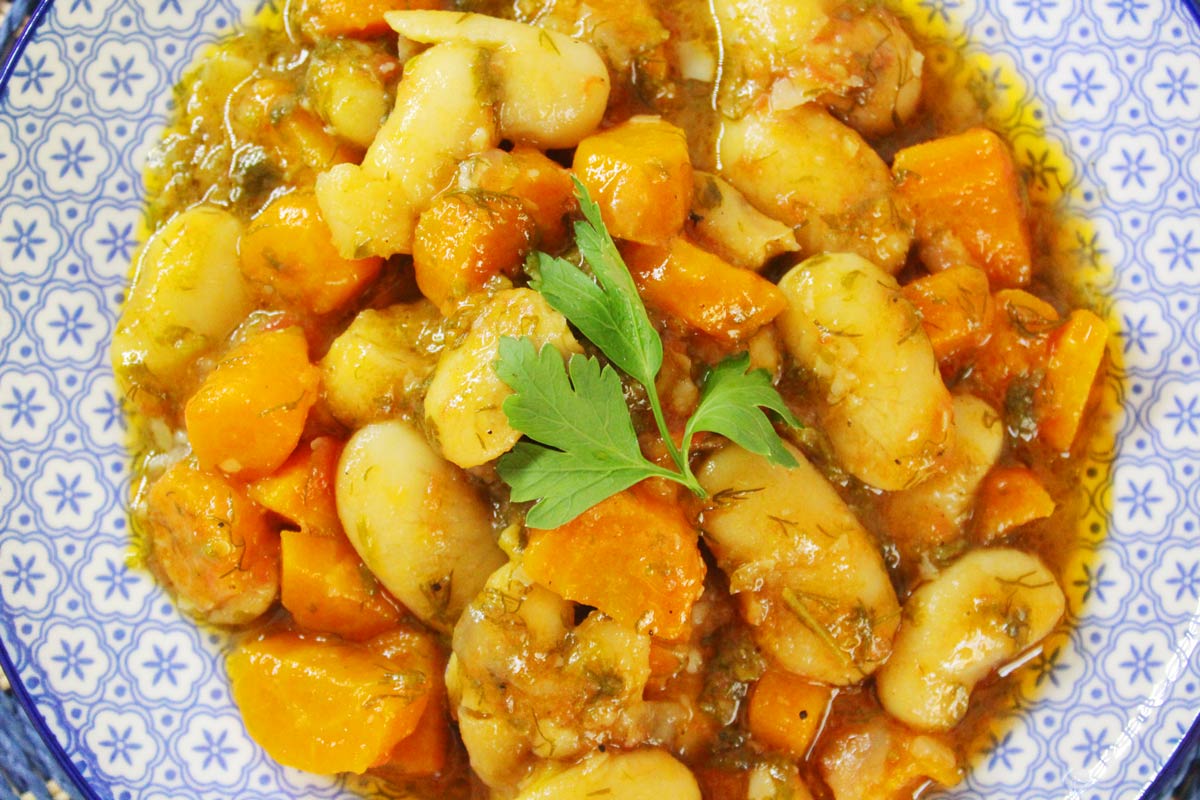 An ethnic plate that contains Greek giant beans.