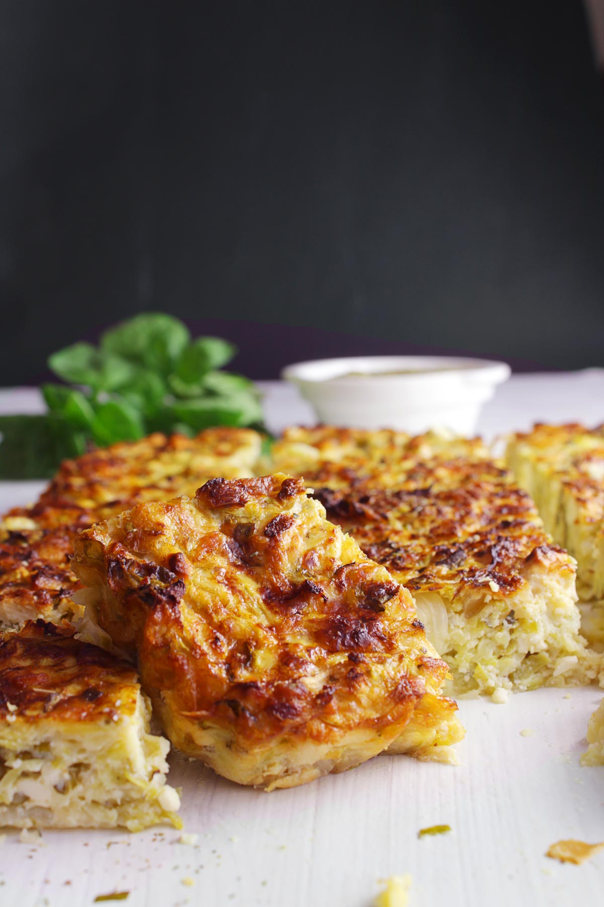 Pieces of Greek zucchini pie on a white platter.