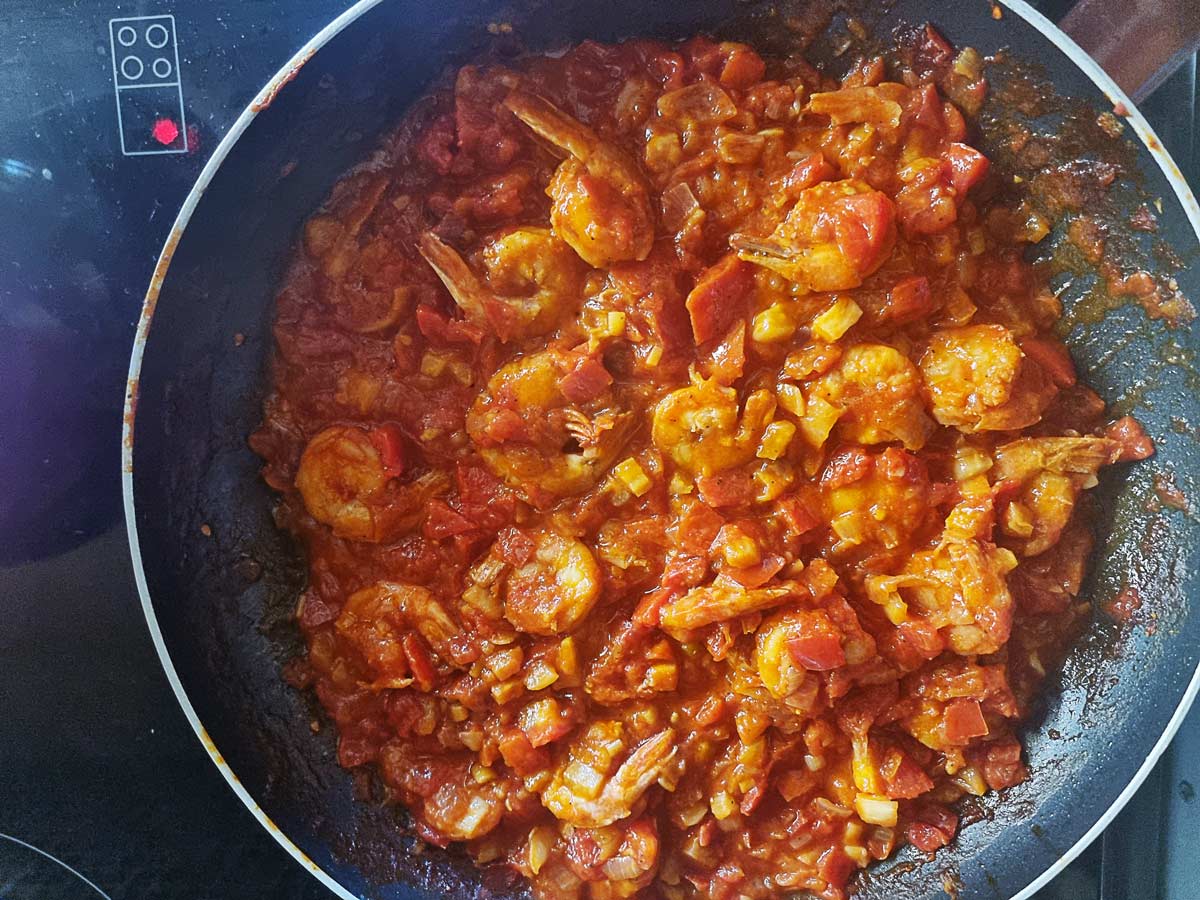 A skillet with Greek shrimp saganaki.