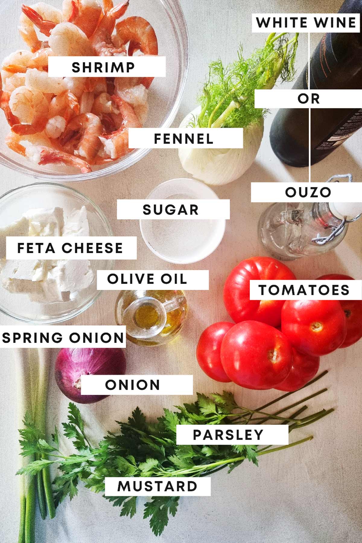 A white board with ingredients for Greek shrimp saganaki.