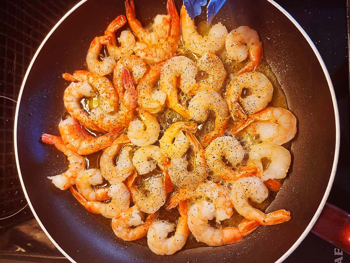 Shrimp sautéed in a pan.