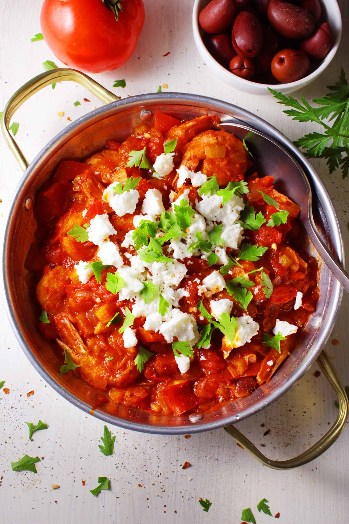 A Greek shrimp saganaki topped with feta and parsley.