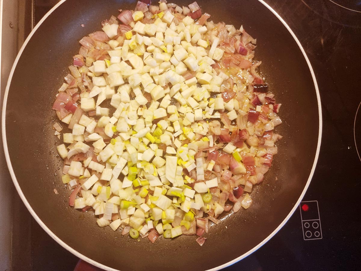A skillet with chopped vegetables.