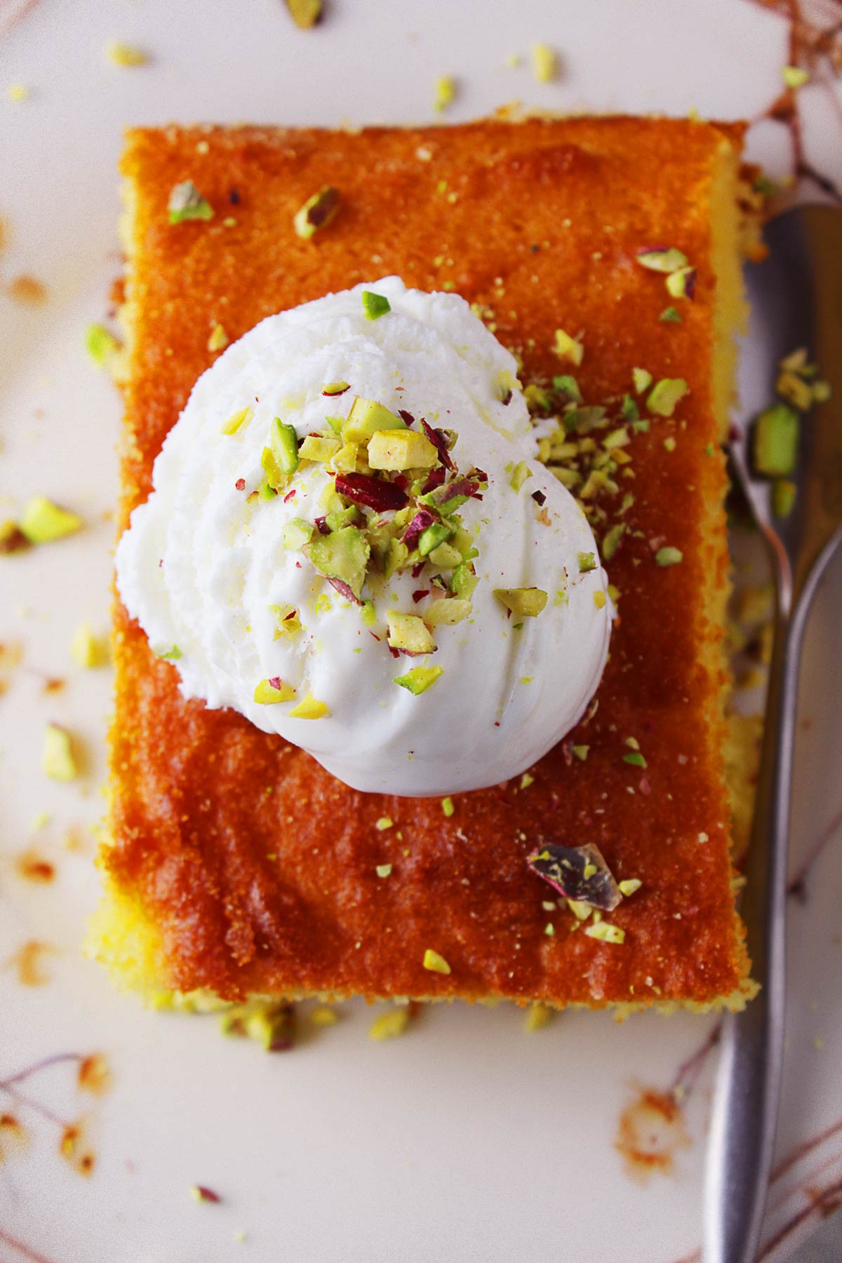 A close photo of a Greek revani peace on a plate.