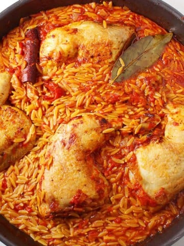 A black baking pan with Greek chicken orzo bake.
