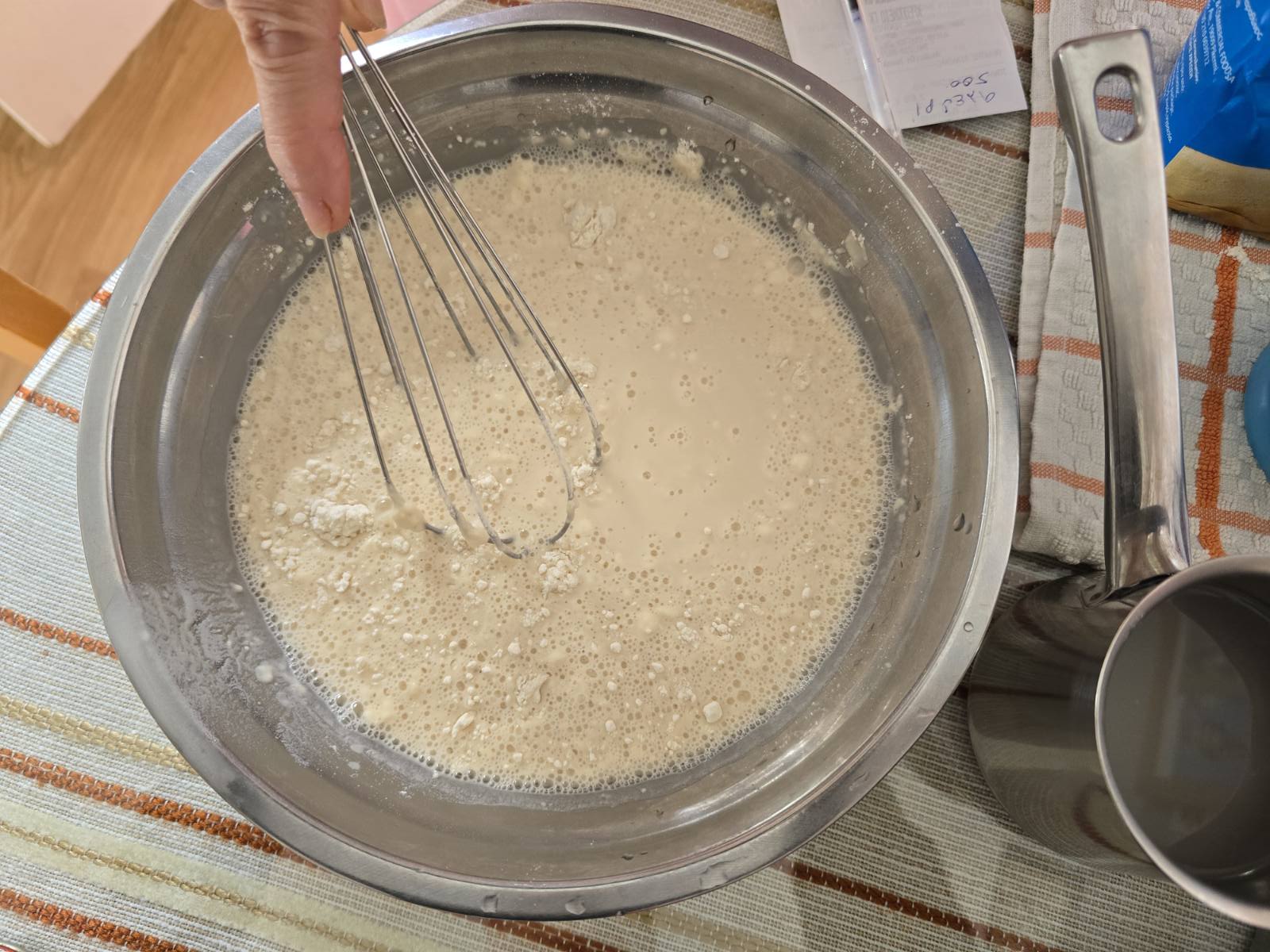 A bowl with ingredients for dough for Greek donuts (loukoumades).