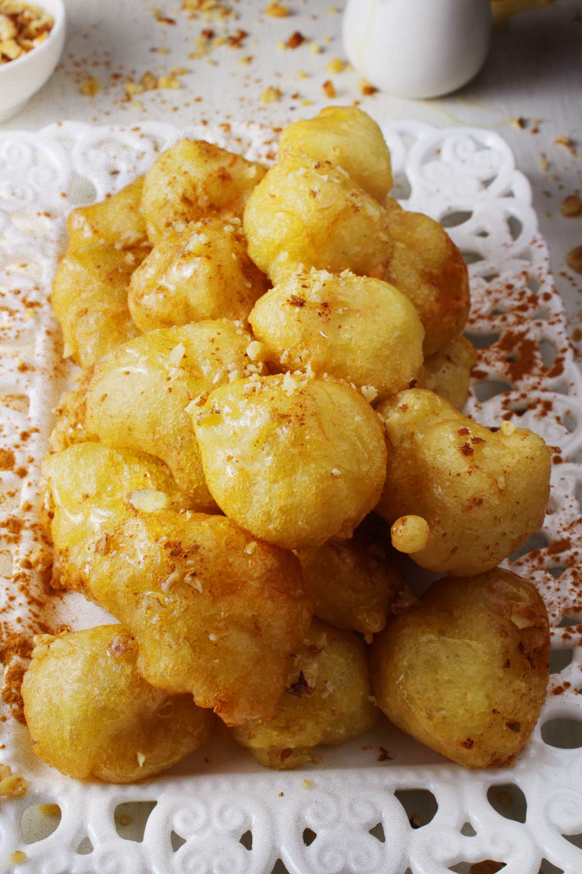 A white platter with Greek donuts (loukoumades).
