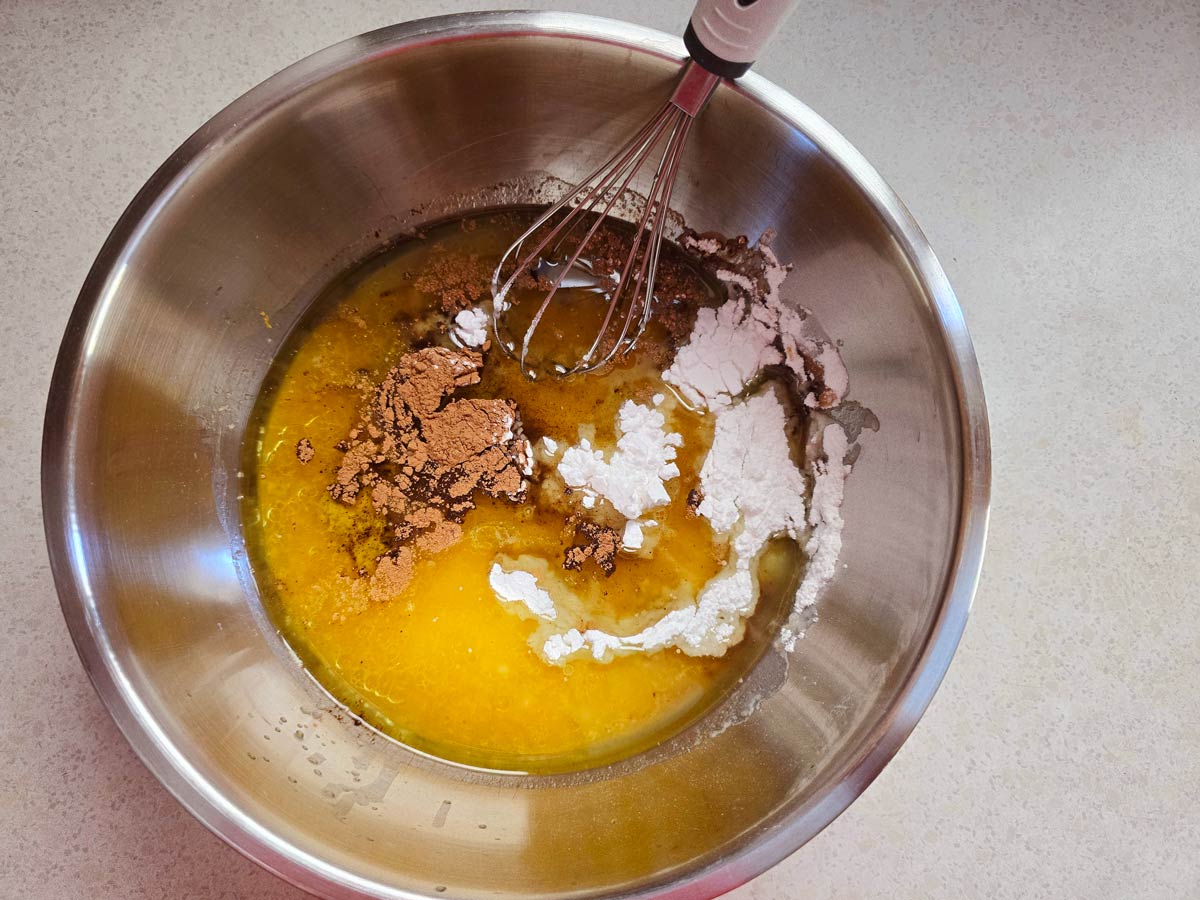 A bowl with wet ingredients for Greek vegan cake.